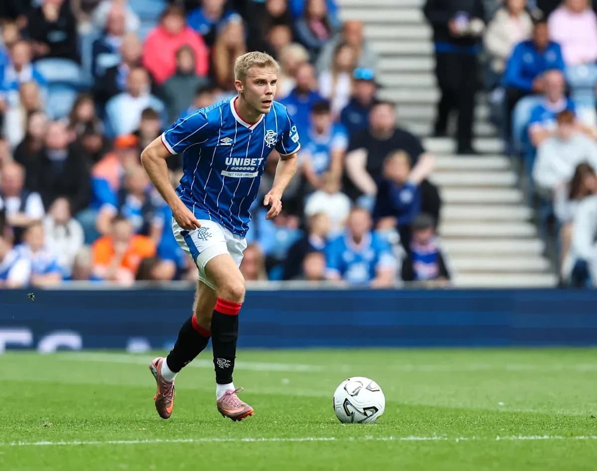 Player in blue kit running with soccer ball