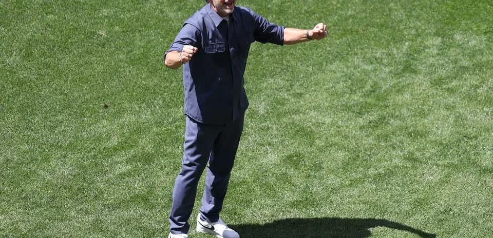 Coach celebrating on the field during practice