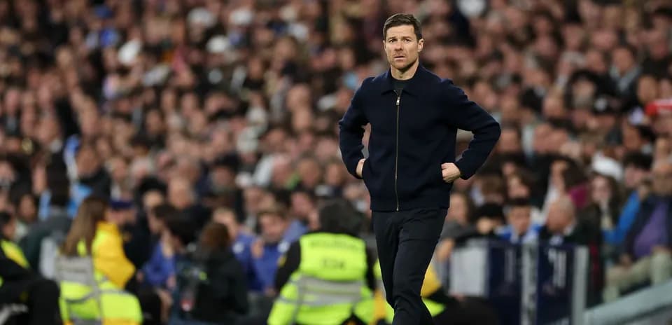 Coach walking along the sideline during match