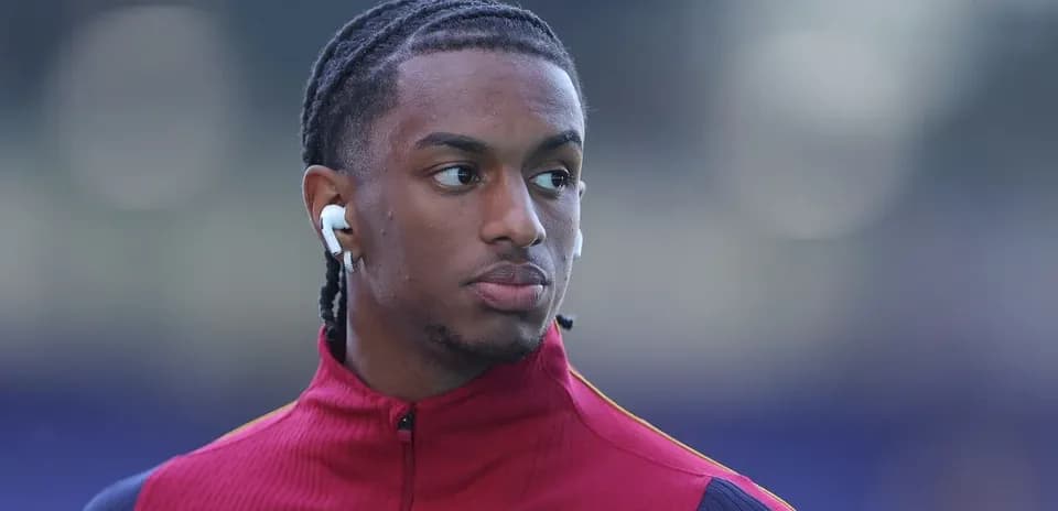 Player wearing earbuds during pre-match warm-up