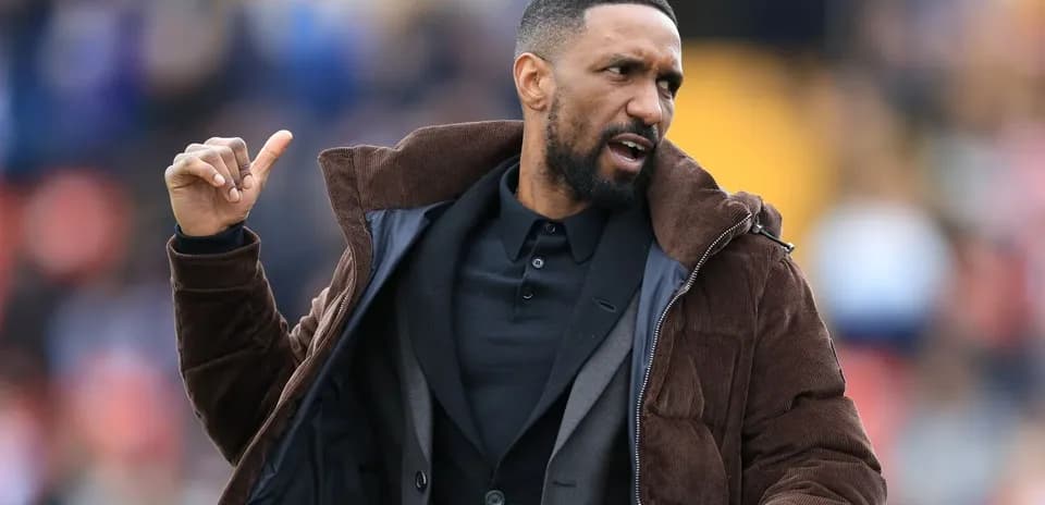 Coach gesturing on the sideline during match