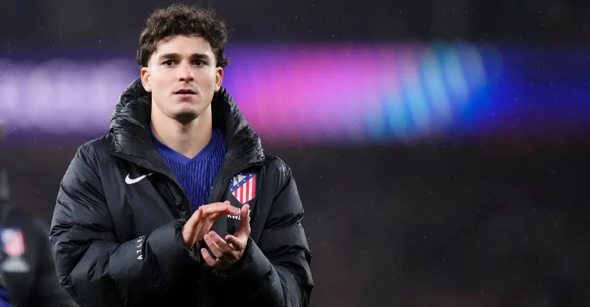 Player applauding while wearing Atletico Madrid jacket