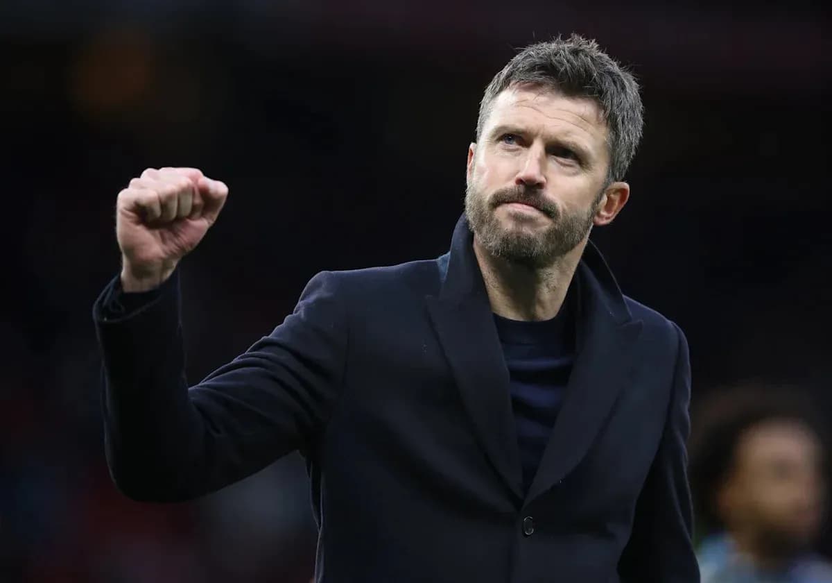 Coach celebrating with a raised fist on the pitch