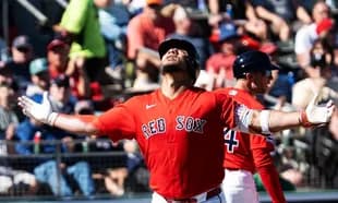 Red Sox player celebrating with fans in background