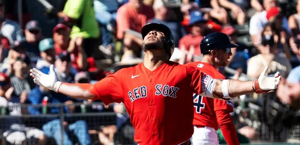 Red Sox player celebrating with fans in background
