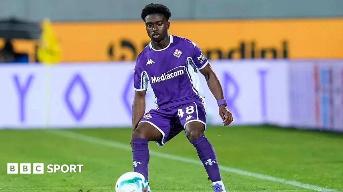 Player in purple kit preparing for play on field