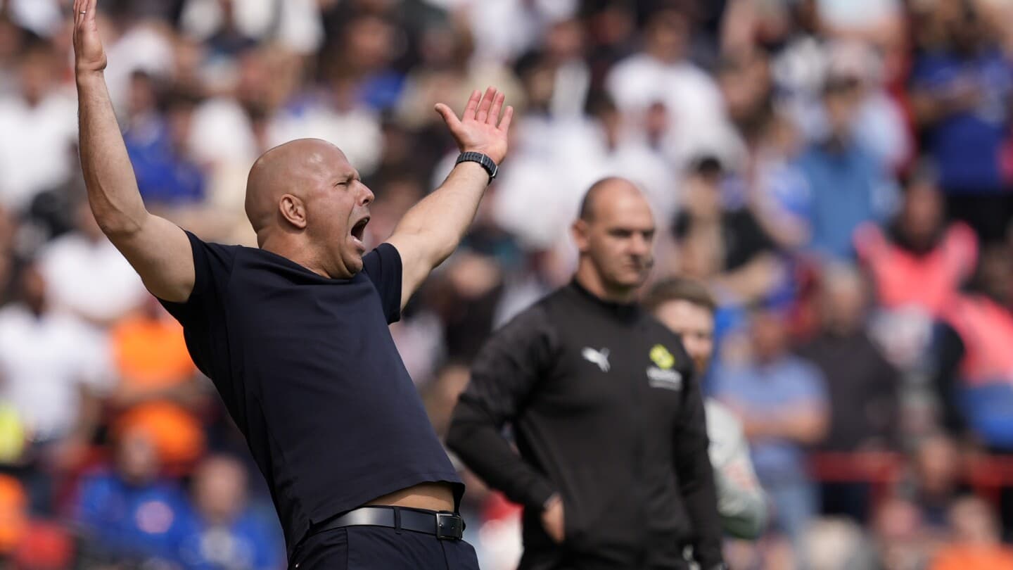 Coach gesturing during match with players in background