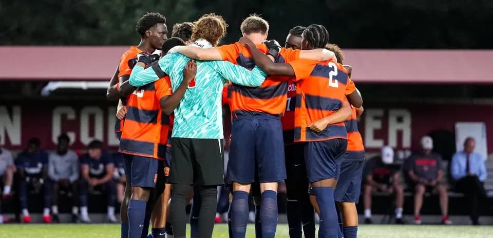 Soccer team huddled together before the match