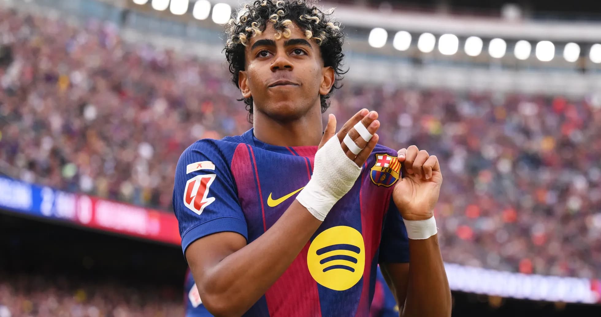 Player celebrating and showing club badge on jersey