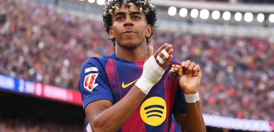 Player celebrating and showing club badge on jersey