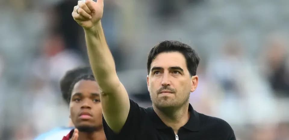 Coach giving thumbs up during match celebration