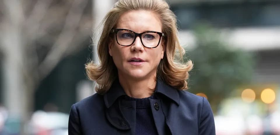 Woman in glasses walking outside with blurred background