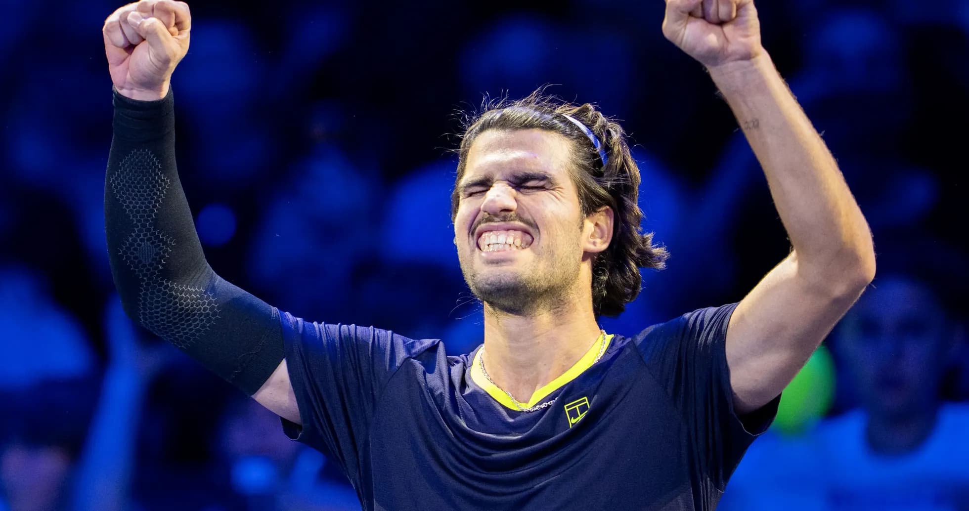 Tennis player celebrating victory with raised fist