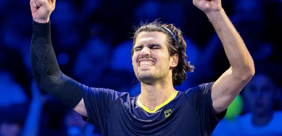Tennis player celebrating victory with raised fist