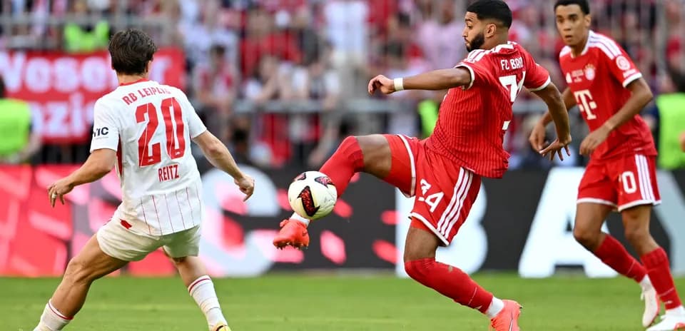 Player passing the ball during a football match
