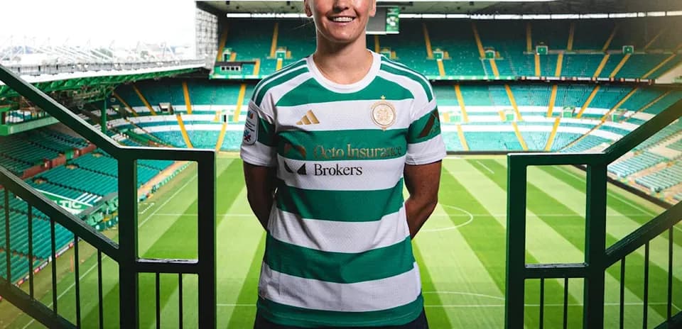 Player posing in Celtic jersey at stadium