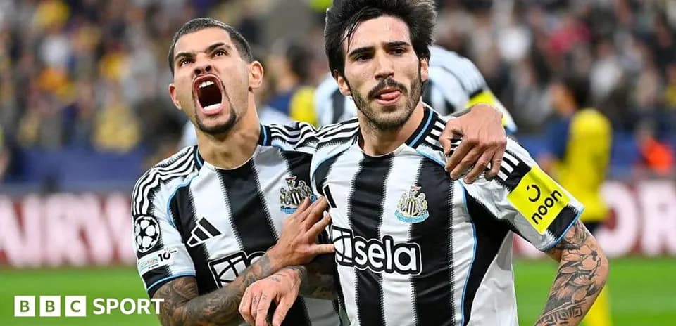Newcastle players celebrating a goal on the pitch