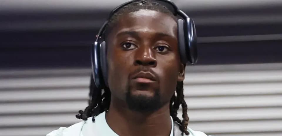 Player wearing headphones while walking indoors