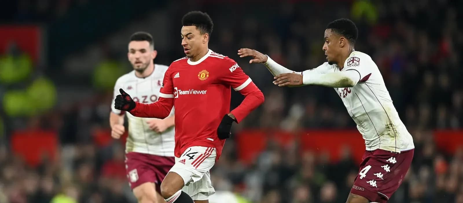 Manchester United player dribbling past Aston Villa opponent