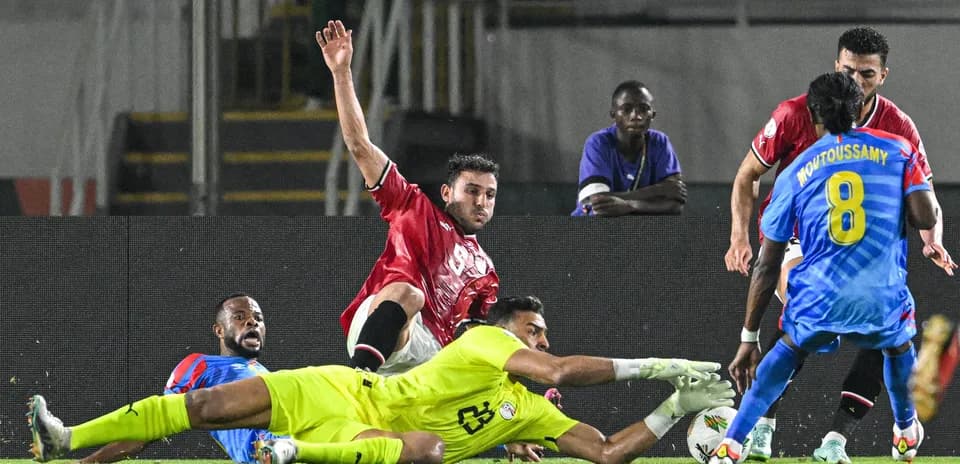 Players contesting the ball near the goal line