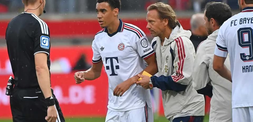 Bayern Munich player receiving medical attention on pitch