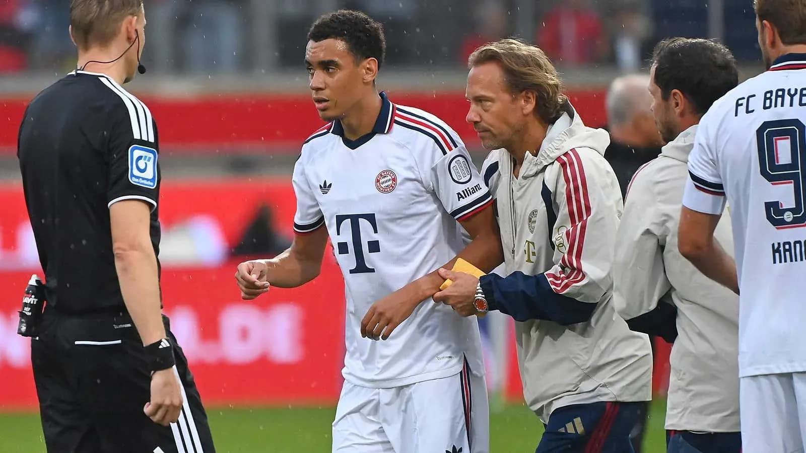Bayern Munich player receiving medical attention on pitch