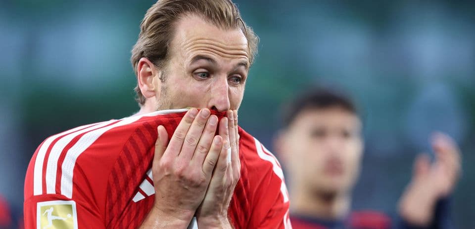 Player covering face with shirt after match