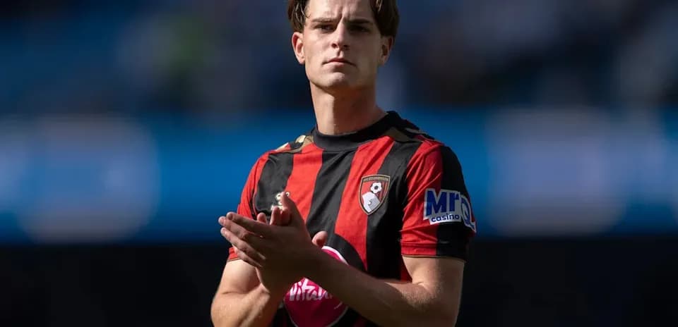 Player in Bournemouth kit applauding fans