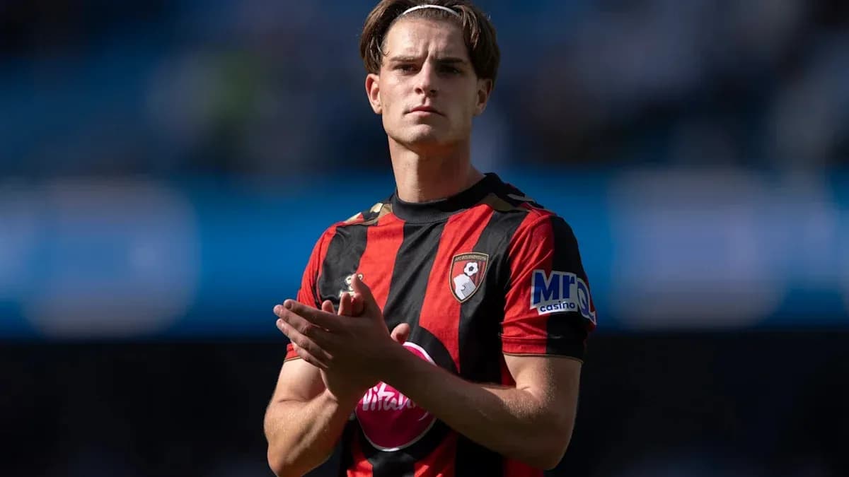 Player in Bournemouth kit applauding fans