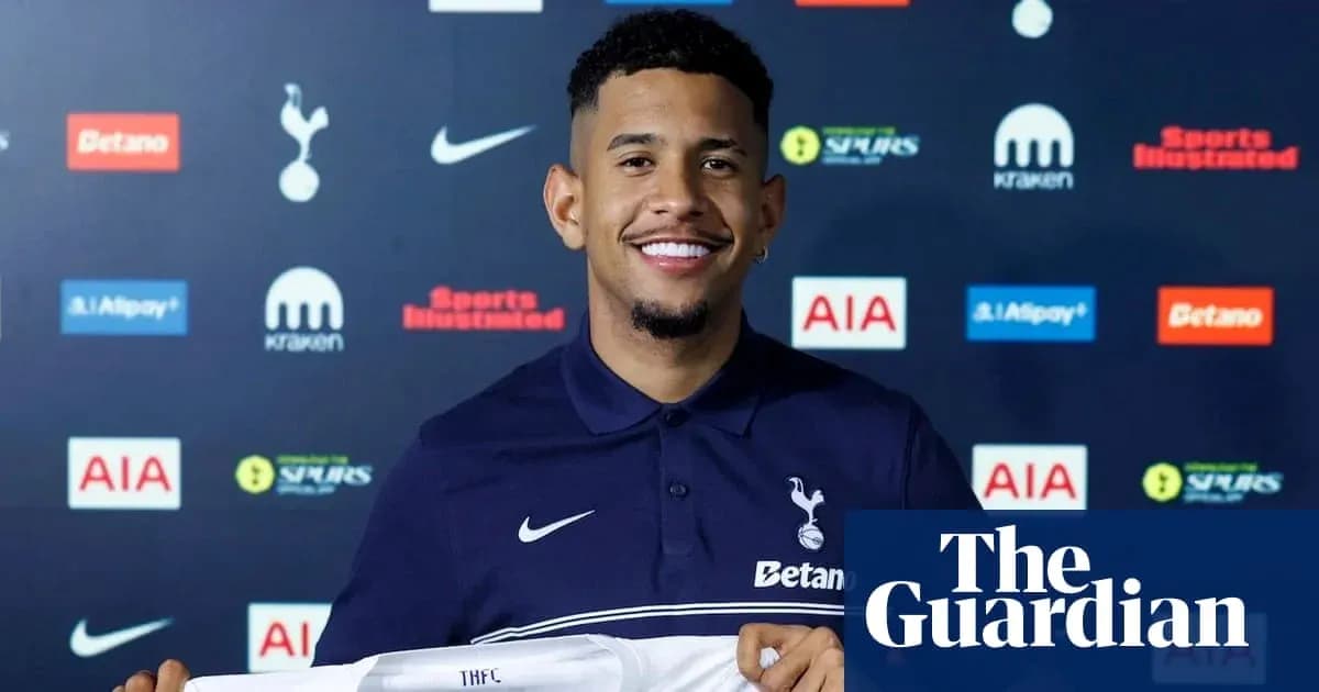 Player holding Tottenham Hotspur jersey at press event