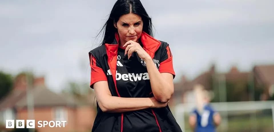 Coach observing training session on the pitch