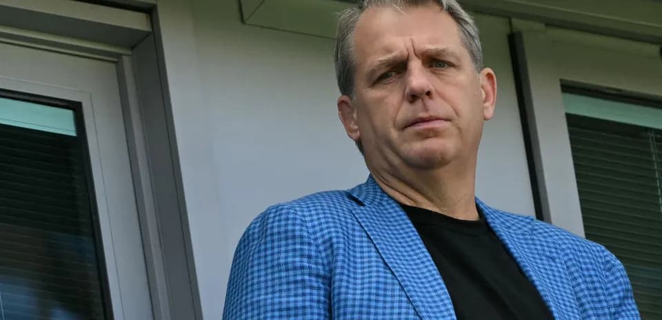 Man in blue blazer looking from a balcony