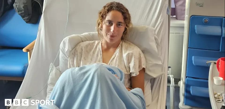 Athlete resting in hospital bed with blue blanket