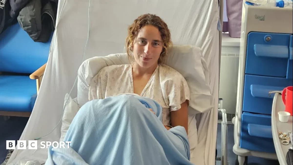 Athlete resting in hospital bed with blue blanket