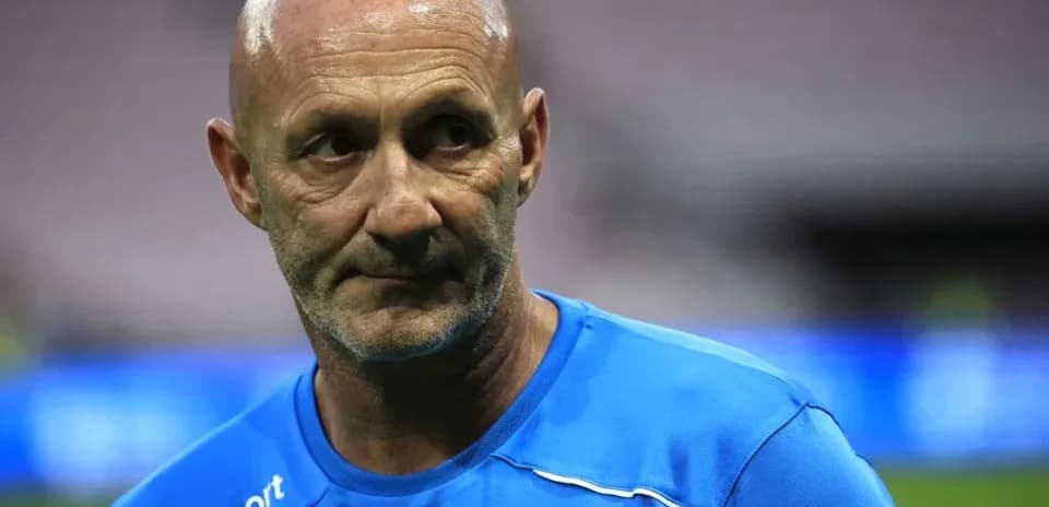 Coach in blue shirt during training session