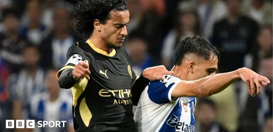 Two players clashing during a football match action