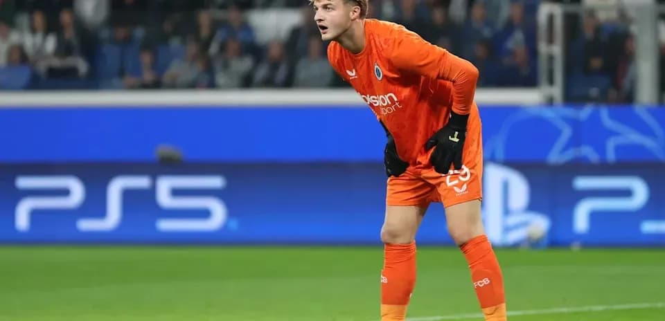 Goalkeeper in orange kit preparing for action