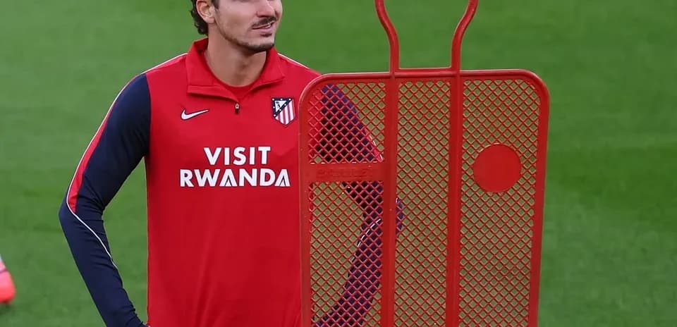 Player standing next to training dummy on pitch