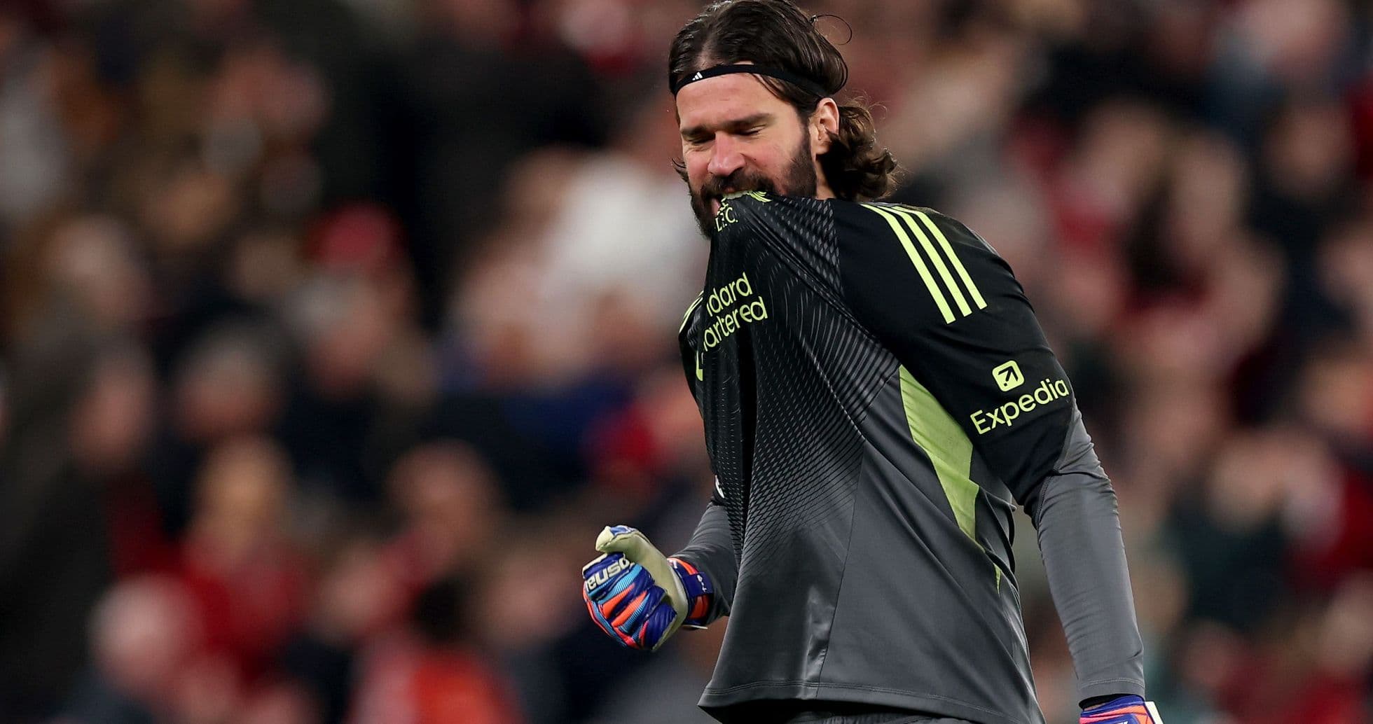Goalkeeper celebrating with gloves during match