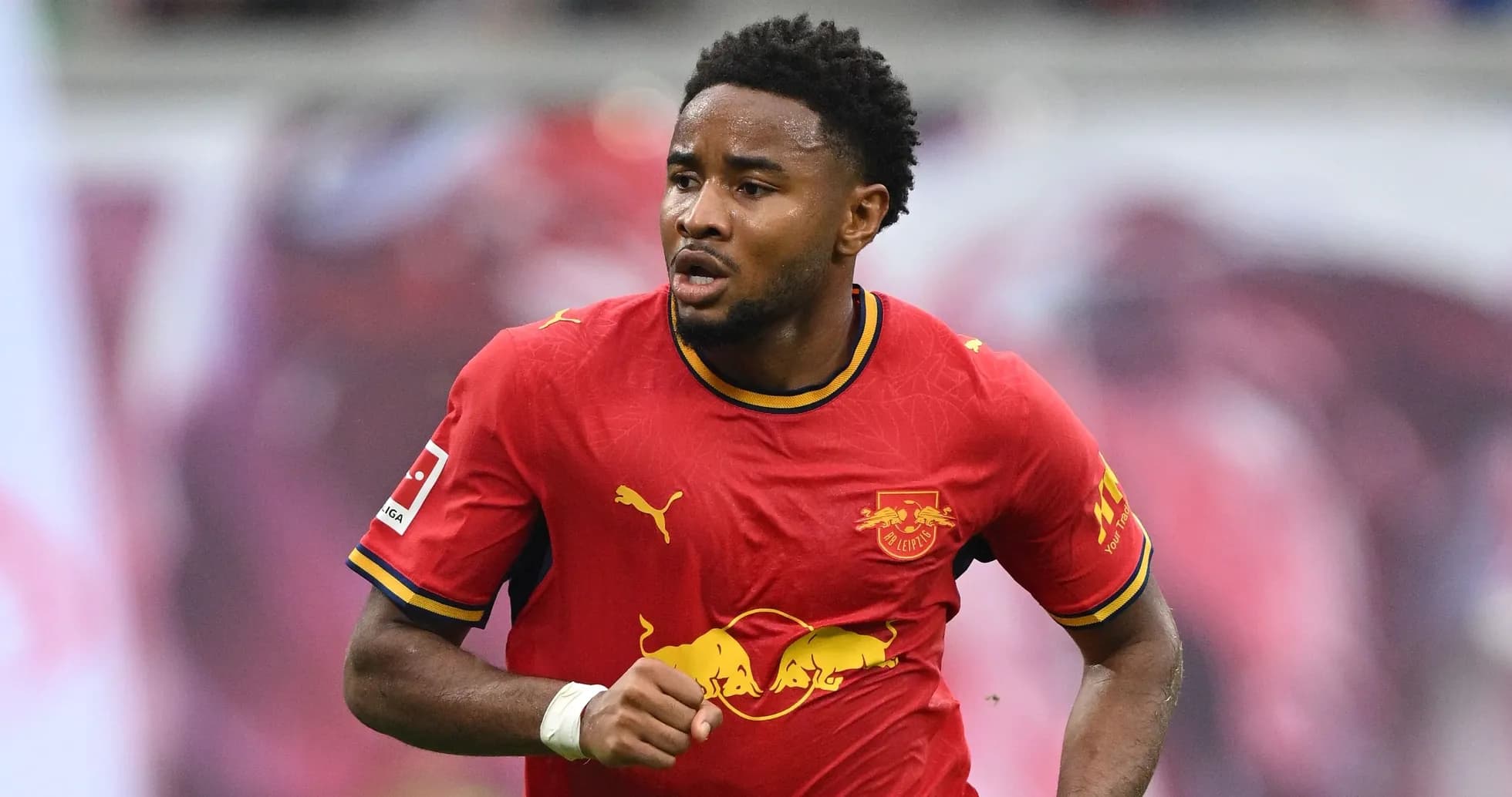 Player running in red RB Leipzig jersey during match