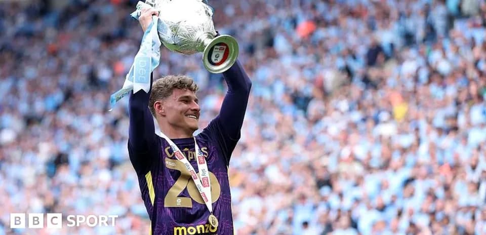 Goalkeeper celebrating with trophy after winning match