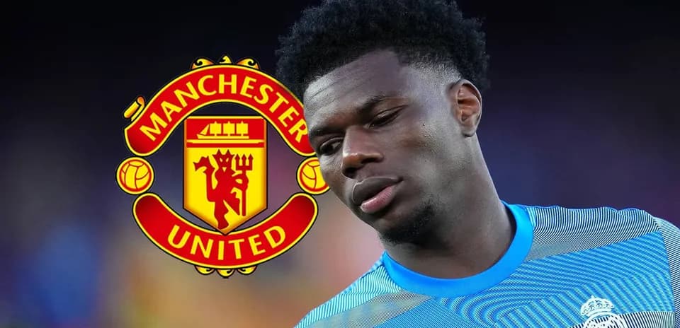 Player in blue kit with Manchester United logo background