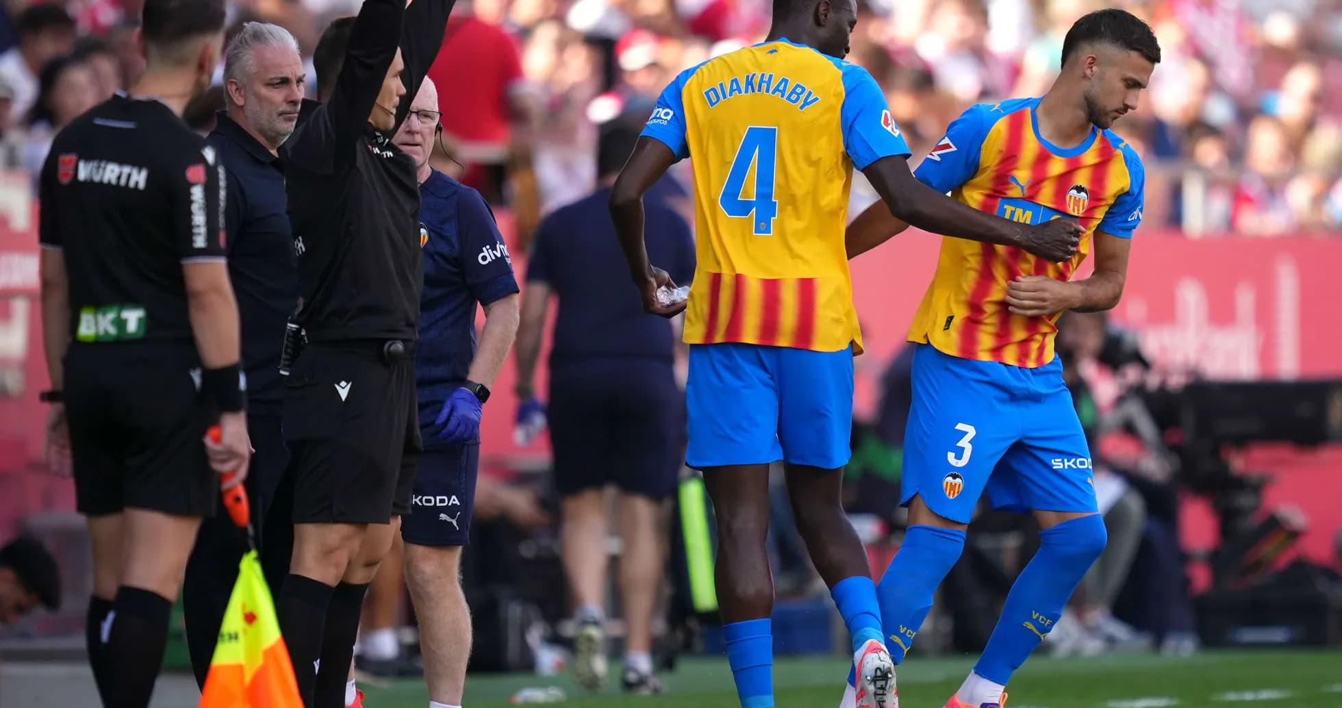 Valencia players preparing for substitution during match