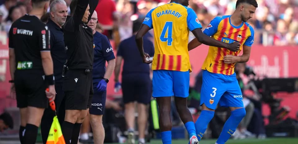Valencia players preparing for substitution during match