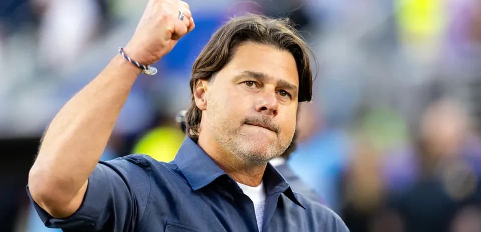 Coach celebrating with raised fist on sidelines