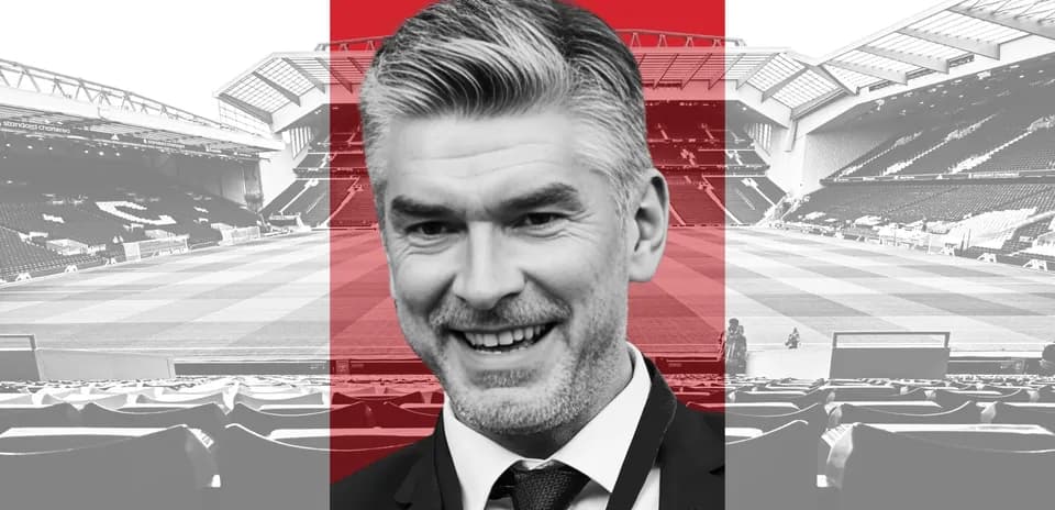 Man smiling in front of football stadium background