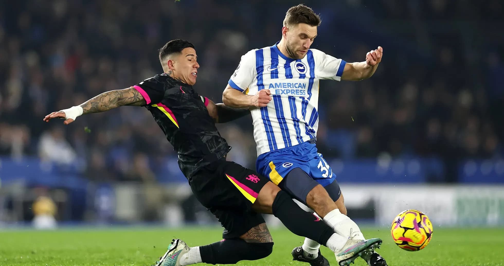 Brighton player tackling Chelsea opponent during match