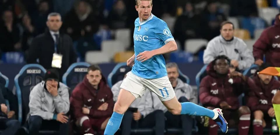 Player in blue jersey running with ball during match