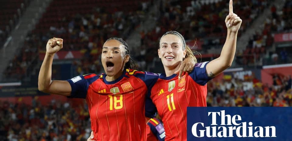 Two Spain players celebrating a goal together