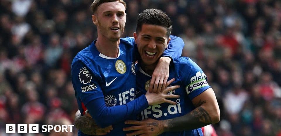 Two players celebrating a goal on the pitch